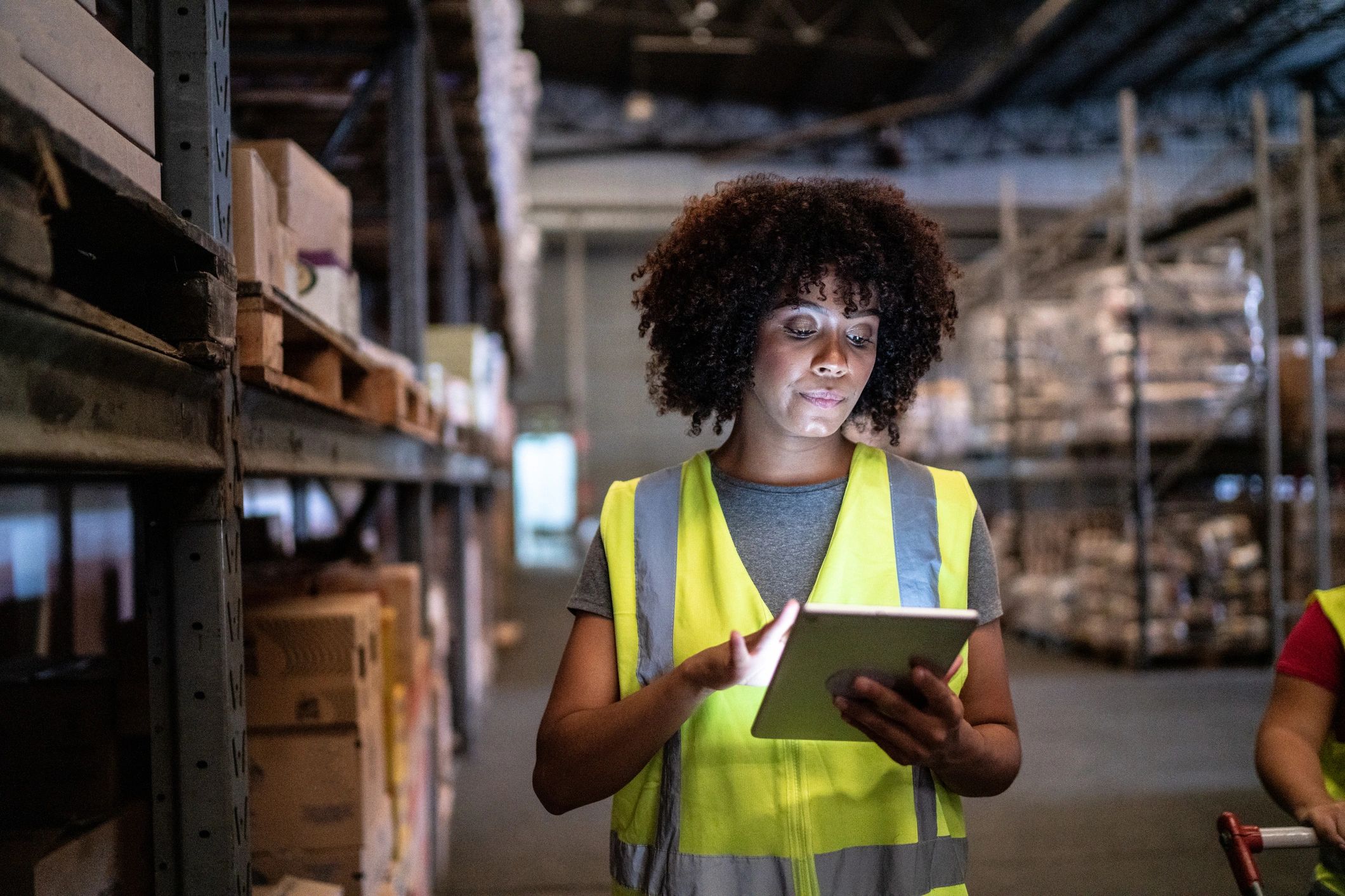 Logistics professional using a tablet in a warehouse